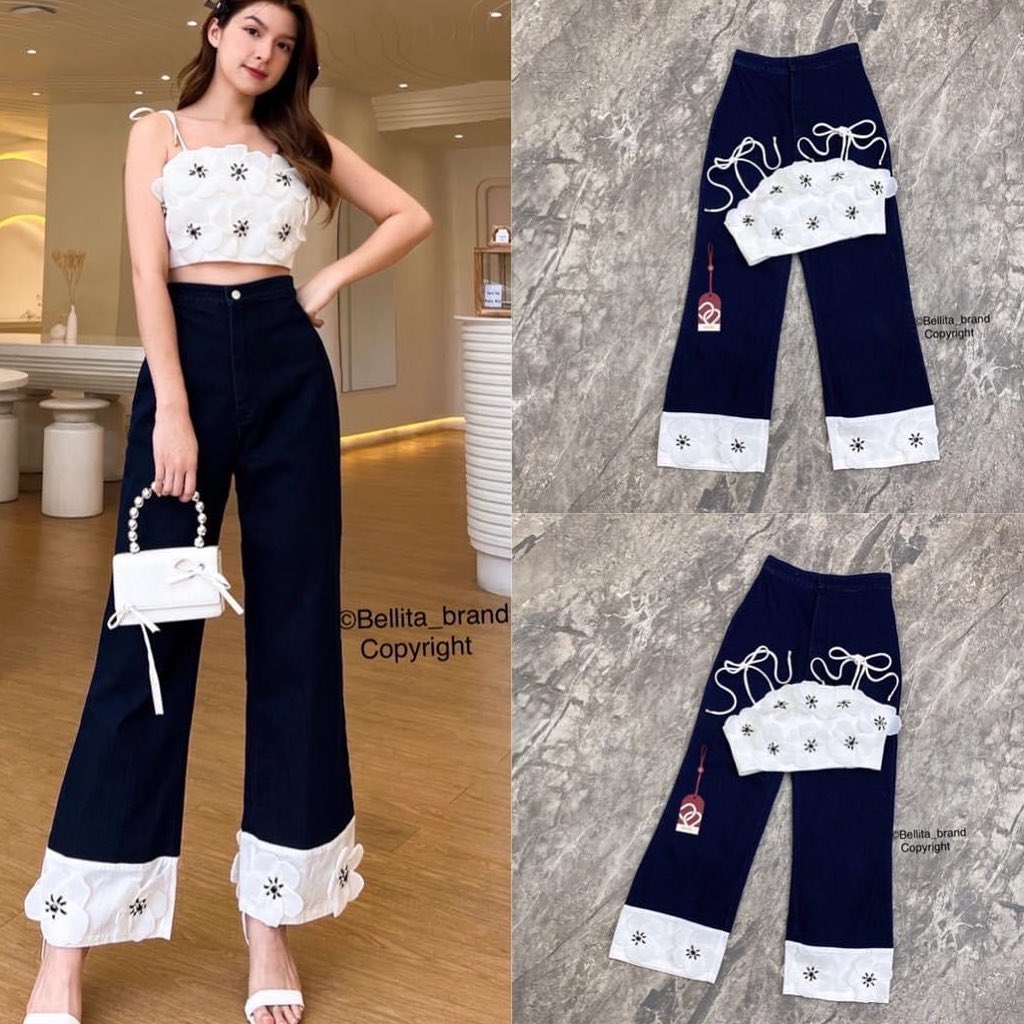 เซ็ทกางเกงยีน เสื้อครอป แต่งดอกไม้สีขาว สายเดี่ยวผูกโบ กางเกงเอวสูงขายาวแต่งปลายขา ปลายขาบานเล็กน้อย . สินค้าคุณภาพ (พร้อมส่ง)