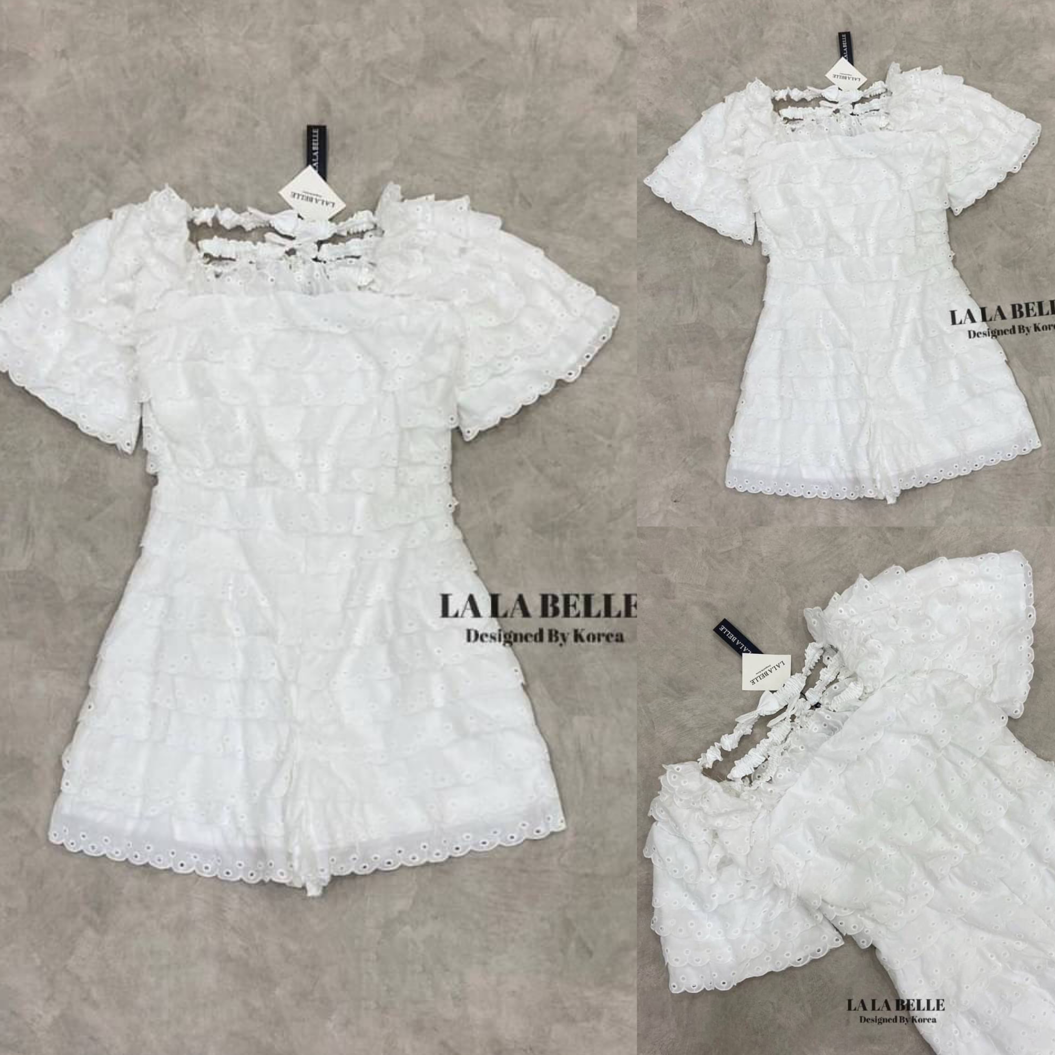 จั้มสูทกางเกงขาสั้นระบายชั้นผ้าปักฉลุหยักๆทั้งชุดคอเหลี่ยมแขนสั้นเอวเข้ารูปกางเกงขาสั้นด้านหลังมีสายคาดแต่งโบเพิ่มความน่ารักมีซับในอย่างดี สินค้าคุณภาพ (พร้อมส่ง)