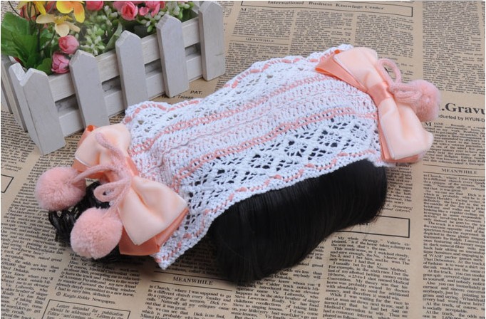 ผ้าคาดผมทารก ถักลายขาวสลับส้ม มีปอมปอมและปอยผมแกะสองข้าง